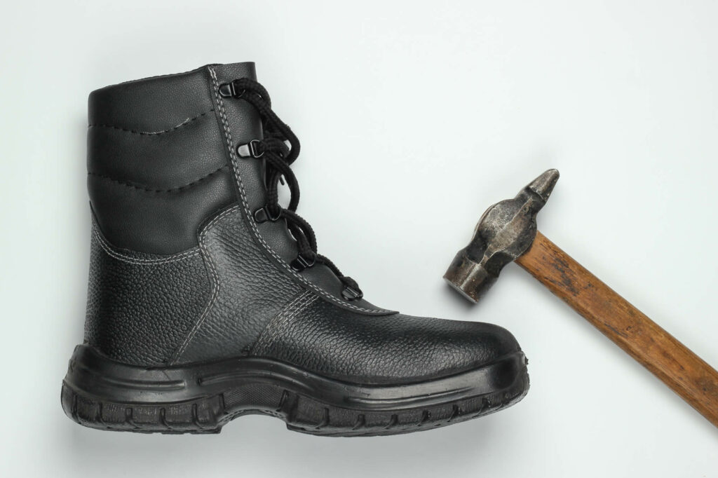Steel work boot and hammer